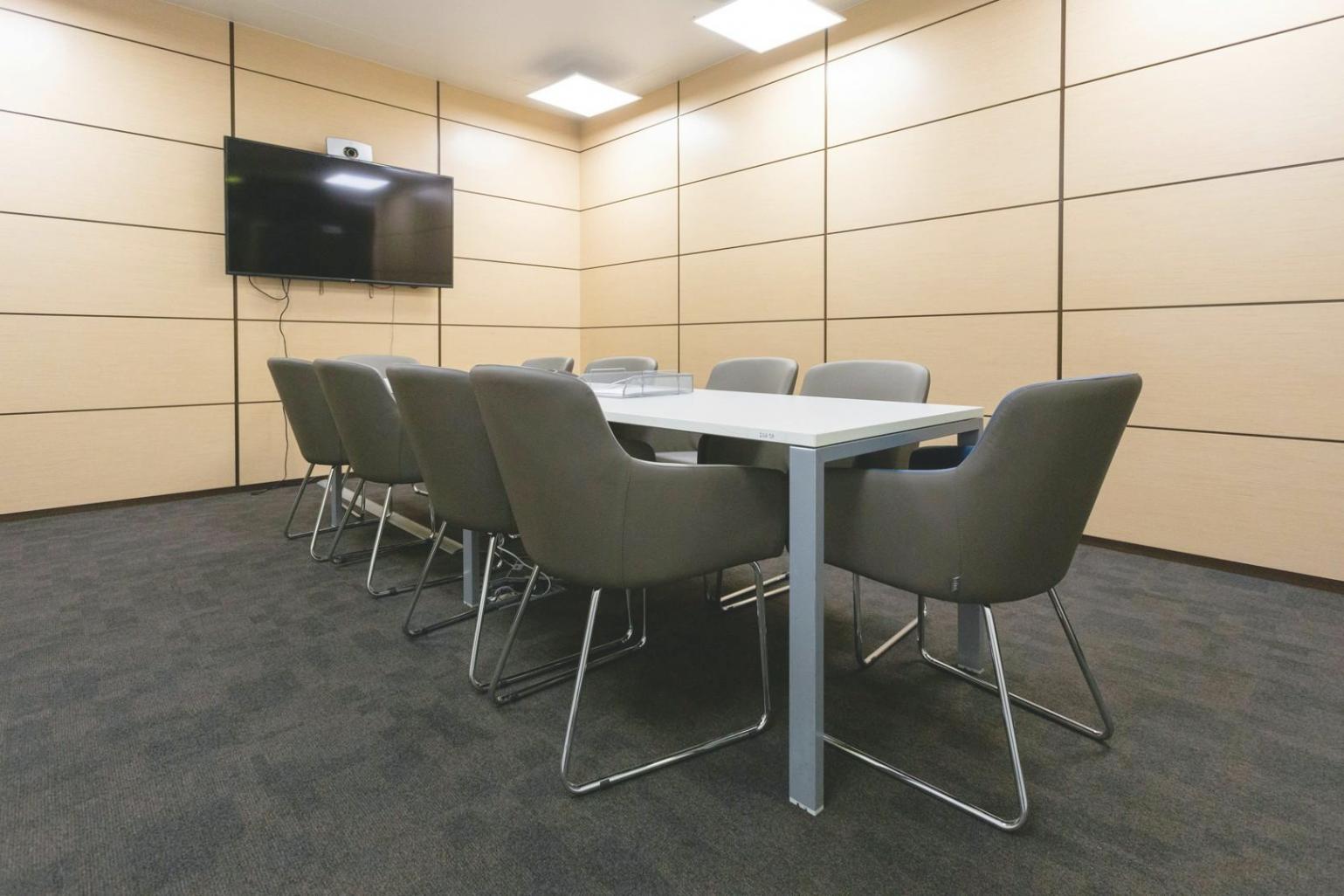 Person reviewing financial documents and progress charts at home office desk